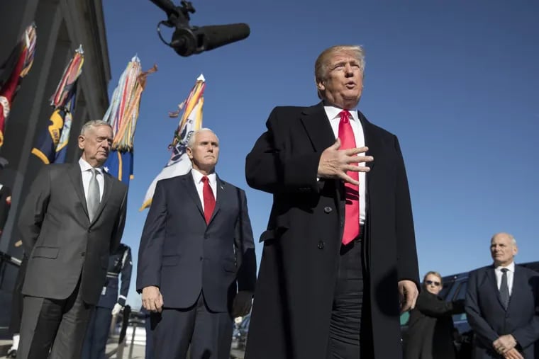 President Donald Trump, joined by Defense Secretary Jim Mattis (far left), Vice President Mike Pence, (second from left) and White House Chief of Staff John Kelly (right) speaks to the media as he arrives at the Pentagon last month.