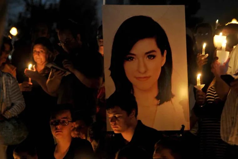 Christina Grimmie's photo looms large at a vigil June 13, 2016, in Evesham Township. Grimmie was shot and killed in Florida while signing autographs.