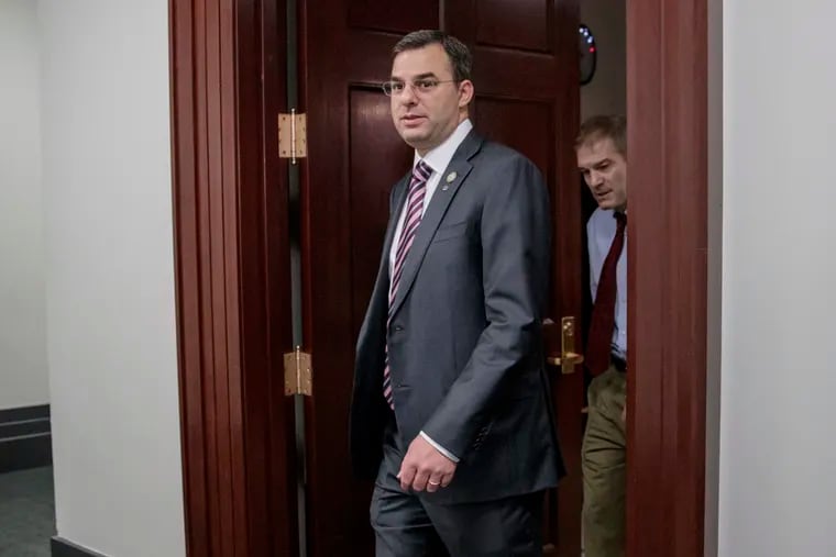 FILE - This March 28, 2017, file photo shows Rep. Justin Amash (R., Mich.), followed by Rep. Jim Jordan (R., Ohio), leaving a closed-door strategy session on Capitol Hill in Washington. Amash isn’t taking back his call for President Trump’s impeachment. The fourth-term congressman took considerable heat on Monday, May 20, 2019, for tweeting over the weekend that special counsel Robert Mueller’s report outlined obstruction by the president.