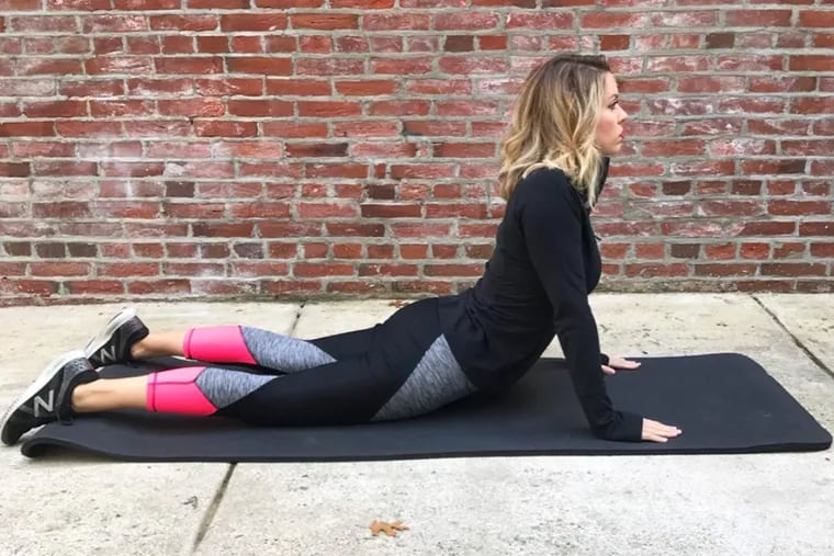 Ashley demonstrates a cobra pose in a 2018 file photo.