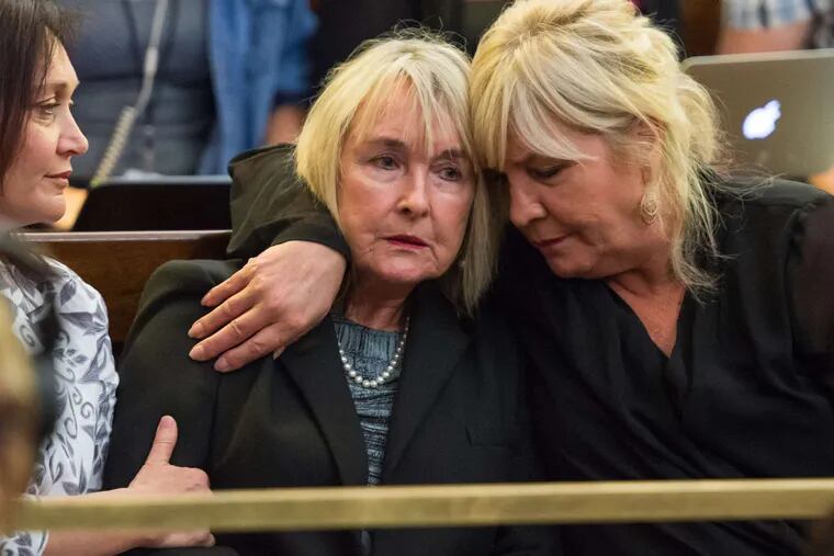 June Steenkamp (center), the mother of Oscar Pistorius' girlfriend Reeva Steenkamp, is comforted as the appeals court delivers the verdict in Bloemfontein, South Africa.