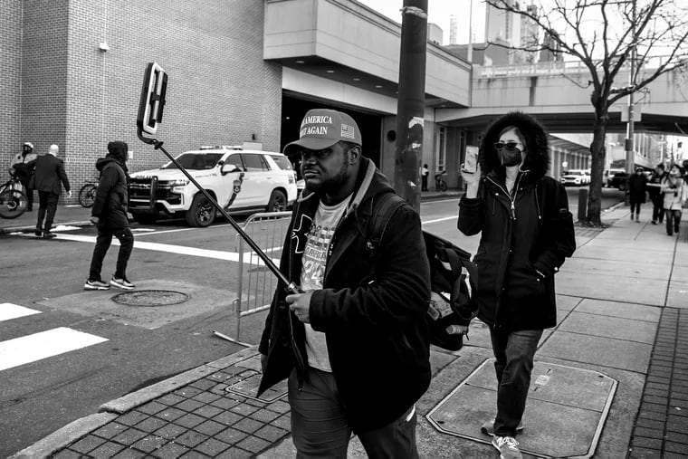 February 19. 2024: MAGA supporter James Freeman of Philadelphia, a  social media content provider, vlogs as he seeks a spot outside the Convention Center on Saturday. to get a glimpse — along with a handful of other spectators — of the of former President Donald Trump's motorcade.