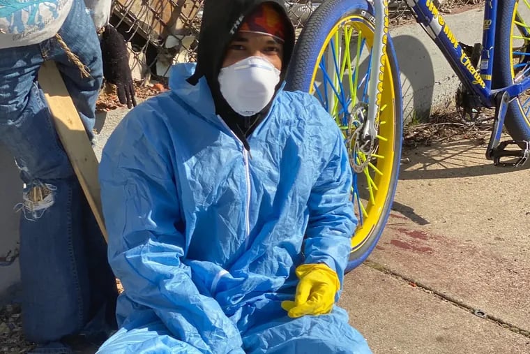 @BikeLifeRex, photographed here, went viral after posting a video a few weeks ago of himself dressed in medical-grade gear, spraying Lysol while standing on his bike and riding through North Philly.