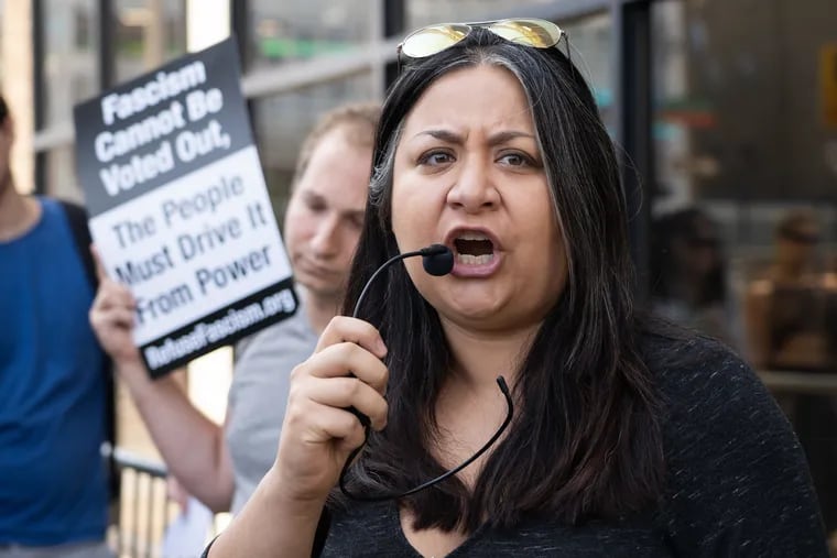 Jasmine Rivera of the Shut Down Berks Coalition speaks outside the ICE field office in Center City during a protest in Philadelphia in August. The Berks family detention center is one of several places in the state where migrants are confined.