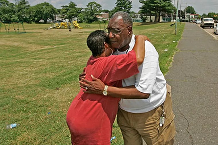 Chester Mayor Wendell  Butler, right, gets a big hug from Chester resident, Joni Williams of 3rd Street , who is thankful for the curfew and hopes that it keeps people safe. (Michael Bryant / Staff Photographer)