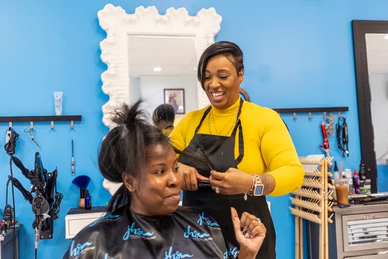 File: Atiya Johnson, 38, of Clementon, N.J., owner of Jana’s Hair Salon and Jana’s Cosmetology Academy, is working on the hair of Kenya Linton, 44, of West Deptford, N.J.