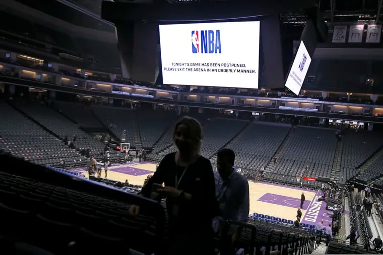 Fans leave the Golden 1 Center after the NBA basketball game between the New Orleans Pelicans and Sacramento Kings was postponed at the last minute in Sacramento, Calif., Wednesday, March 11, 2020. The league said the decision was made out of an "abundance of caution," because official Courtney Kirkland, who was scheduled to work the game, had worked the Utah Jazz game earlier in the week. A player for the Jazz tested positive for the coronavirus.