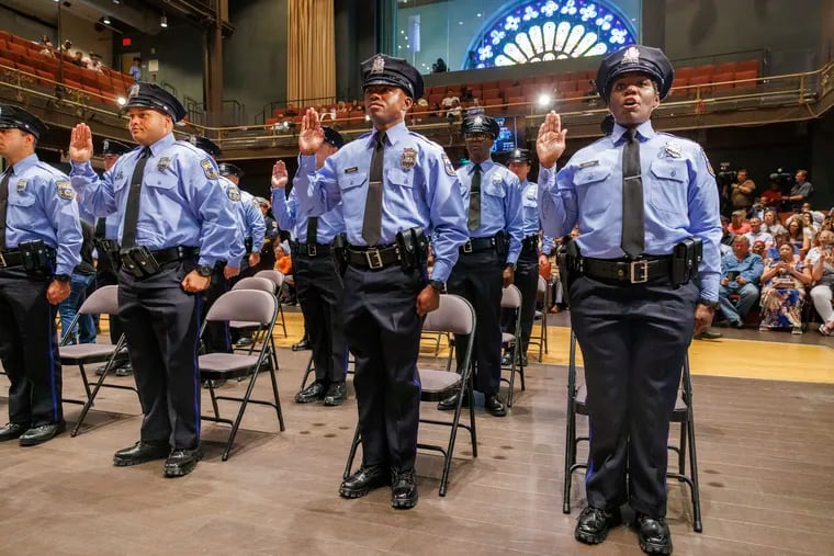 Philadelphia police officers take the oath of office in January 2023 during a graduation ceremony. A new class of cadets enrolled this week and marks the largest class since March 2018, the department said.