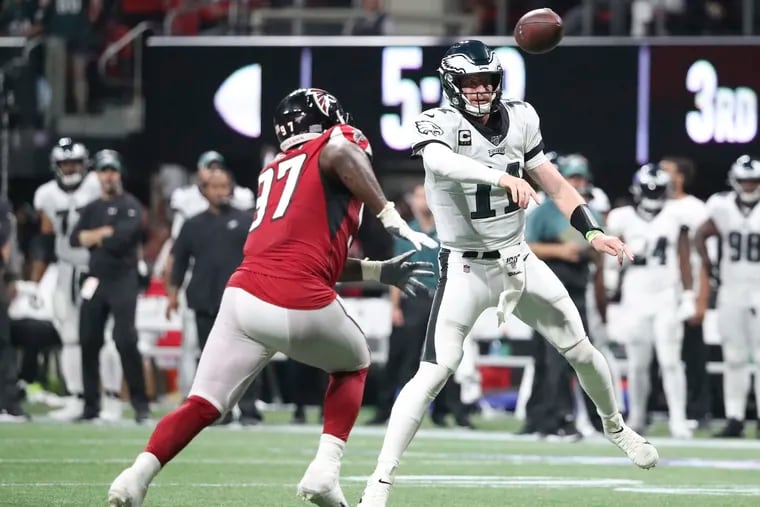 Eagles quarterback Carson Wentz throws the football past Atlanta Falcons defensive tackle Grady Jarrett during the third-quarter on Sunday, September 15, 2019 in Atlanta.