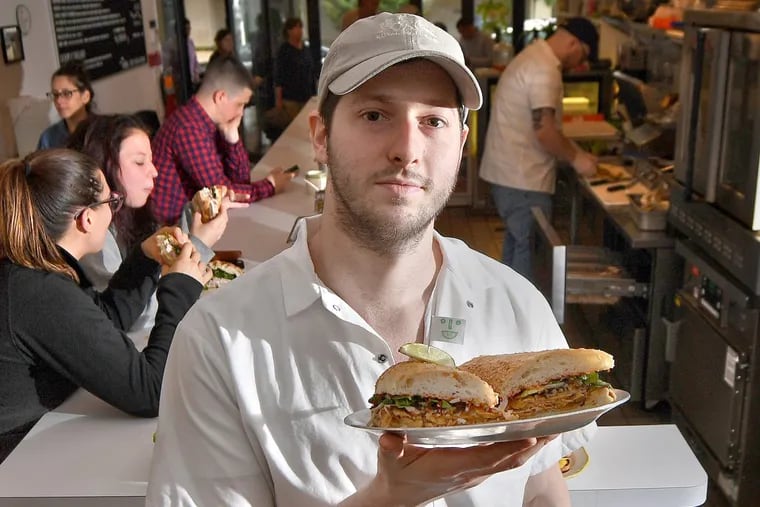 Matt Cahn, co-owner and chef at Middle Child, holds a vegan Phoagie.