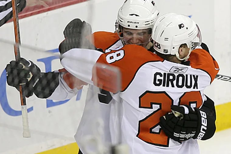 Flyers' Claude Giroux celebrates his first-period power play goal with teammate Matt Carle. (Yong Kim / Staff Photographer)