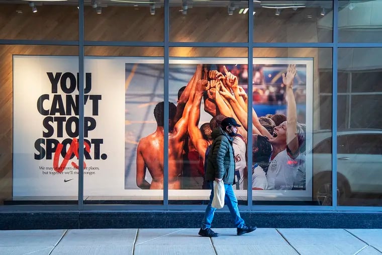 A man walks near the Nike store in the Fashion District Philadelphia mall in Center City. A bankruptcy court judge has approved owner PREIT's proposed restructuring plan.