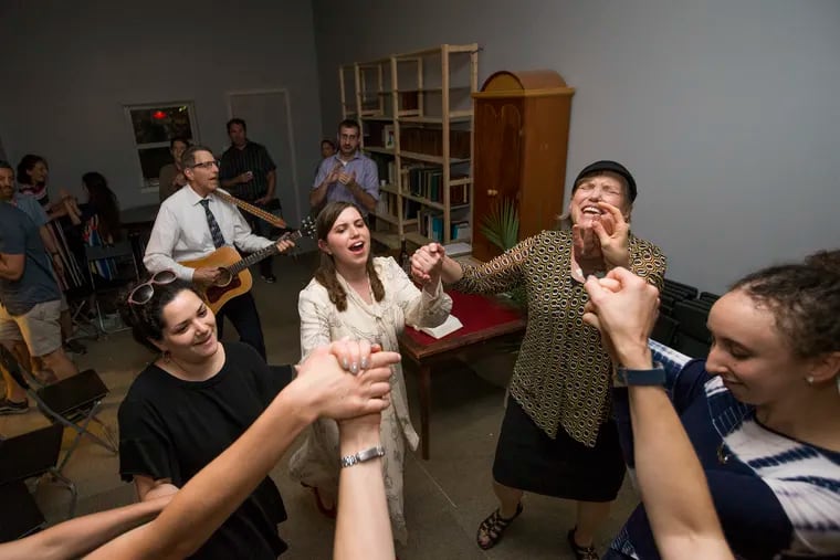 Rabbanit Hadas Fruchter (center) leads a new synagogue in South Philadelphia to serve its growing Jewish community. After Havdalah (the traditional ceremony ending the Sabbath), the synagogue was having a kumsitz, a musical celebration.