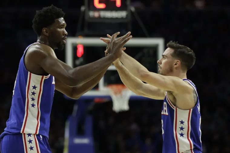The Sixers’ Joel Embiid (left) and T.J. McConnell celebrate during their win against the Trail Blazers on Wednesday, Nov. 22, 2017.