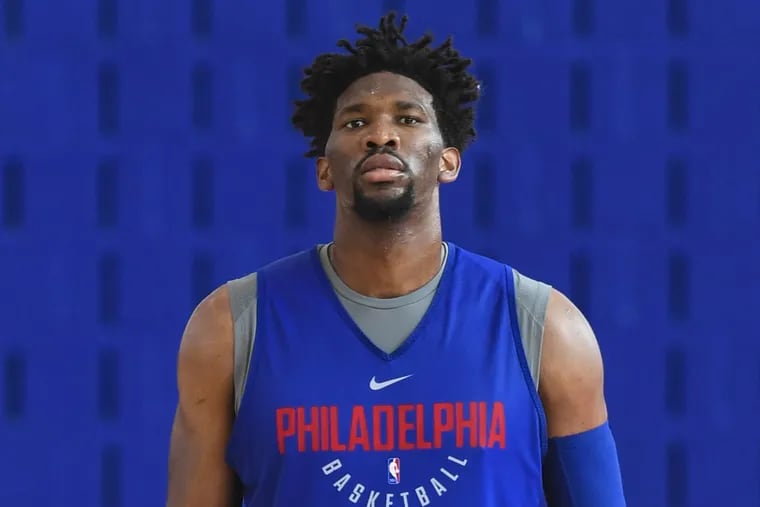 Sixers center Joel Embiid, taking a break during Sixers training camp Thursday.