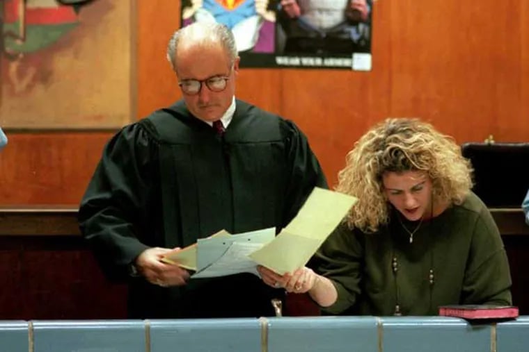 Judge Seamus McCaffery goes over the night's paperwork with his wife, Lisa Rapaport, who was standing in for court clerk because the usual clerk was sick.