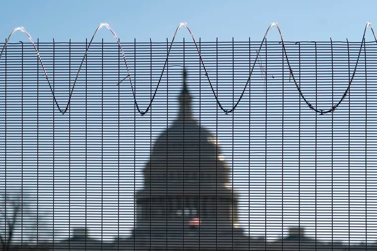 This Feb. 25 photo shows fencing and razor wire surrounding the perimeter of the Capitol in Washington.