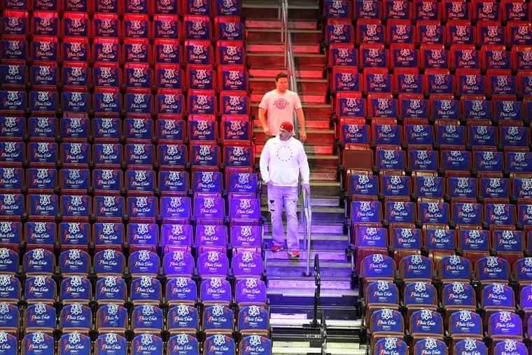 The first couple of fans make their way into the Wells Fargo Center ahead of Game 6 of the Eastern Conference Semifinals between the Sixers and Toronto Raptors on May 9, 2019. With the current NBA season suspended due to the coronavirus pandemic, the league is faced with the problem of figuring out how to resume play if and when it can.