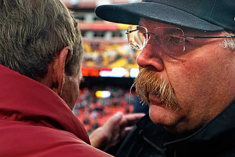 Eagles head coach Andy Reid talks with Redskins head coach Mike Shanahan after the game. (Ron Cortes/Staff Photographer)