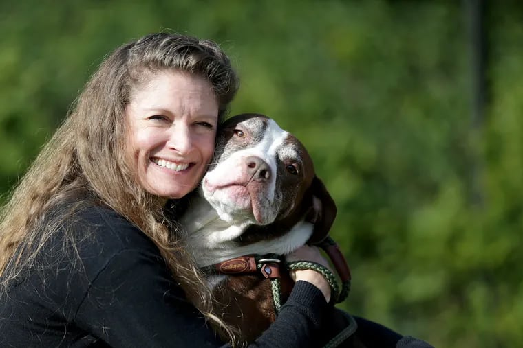 Susan Russell, has stepped down as ACCT's executive director, hugs Bob at the animal shelter in October 2018, shortly after she started her tenure.