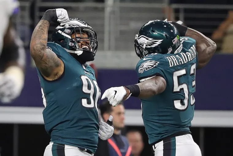 Eagles’ Derek Barnett, left, and Nigel Bradham, right, celebrate after Barnett forced a fumble and Bardham returned it for a touchdown against the Cowboys. Philadelphia Eagles win 37-9 over the Dallas Cowboys in Arlington, Texas on November 19, 2017.