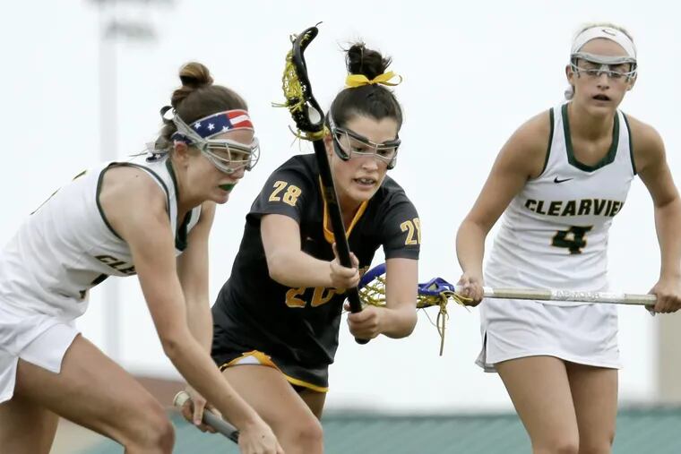 Moorestown’s Kacey Knobloch (center) and  Clearview’s Joanna Bakey (left) and race to a loose ball as Clearview’s Alyssa DeAngelo looks on during the second half of Moorestown’s win over Clearview on Saturday.