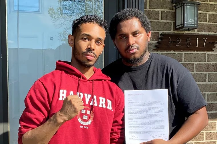 Rehan Staton, 24, left, with his brother Reggie Staton, 27, after he was accepted to Harvard Law School in March.