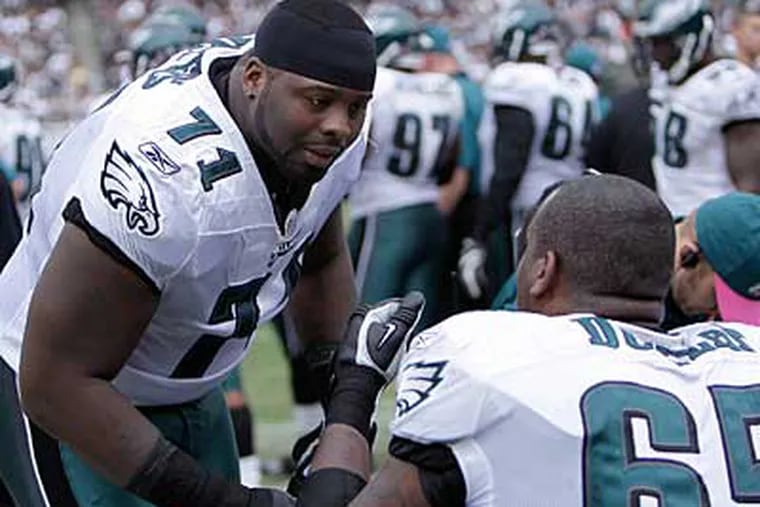 Jason Peters, left, talks with King Dunlap on the bench after Peters left the game with an injury in the Eagles' 13-9 loss to the Raiders in October. ( David Maialetti / Staff Photographer )