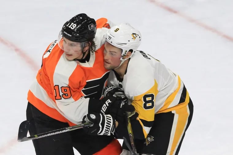 Nolan Patrick (left) battling for position with Pittsburgh’s Brian Dumoulin during the Flyers’ 5-1 loss Tuesday.