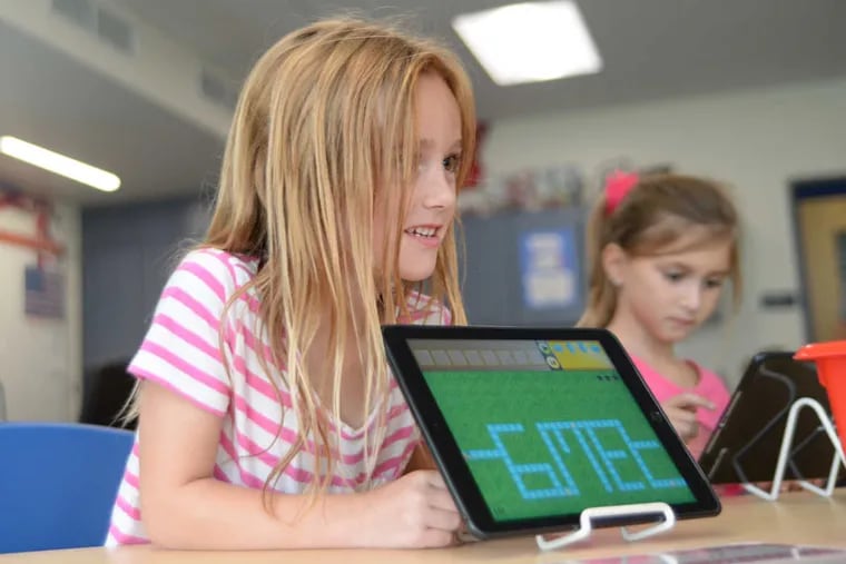 .First-grader Sierra Spurgeon, 6, shows off her progress in a computer programming activity at Ridge Park Elementary School in Conshohocken.