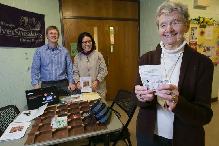 Sarah Daly considers donating lottery tickets to the project at the S. Philadelphia Older Adult Center.