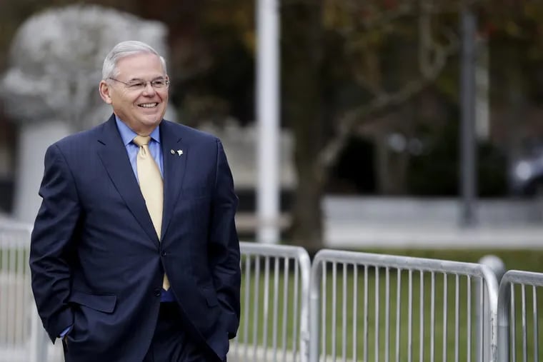 U.S. Sen. Bob Menendez leaves the Martin Luther King Jr. Federal Courthouse after stopping in to appear on his corruption trial, Tuesday, Nov. 14, 2017, in Newark, N.J. Jury deliberations in the bribery trial of Menendez are scheduled to continue amid uncertainty over the fallout from comments made by an excused juror last week. The juror told reporters on Thursday, Nov. 9, that although many jurors appeared to be leaning toward acquittal, she anticipated a hung jury. (AP Photo/Julio Cortez)