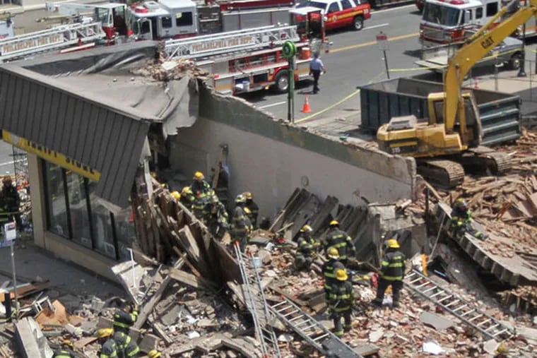 An overhead shot of the scene of the building collapse at 22nd and Market streets. Philadelphia firefighters and police go through the rubble looking for survivors. (Michael Bryant / Staff Photographer)
