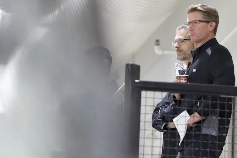 General manager Ron Hextall, left, was fired Monday. Coach Dave Hakstol, right, still has his job, for now at least.