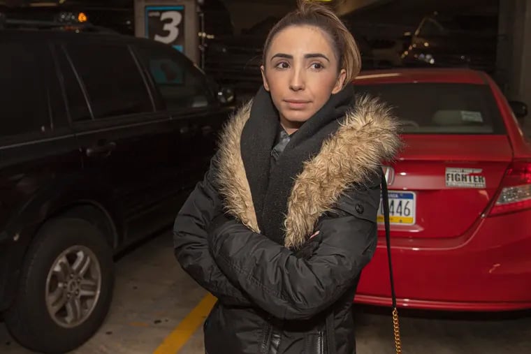Abby Dahan with her car at a Center City parking garage near her home in Philadelphia. Car owners often will find parking tickets on their car because it was moved to an illegal or other temporary spot.