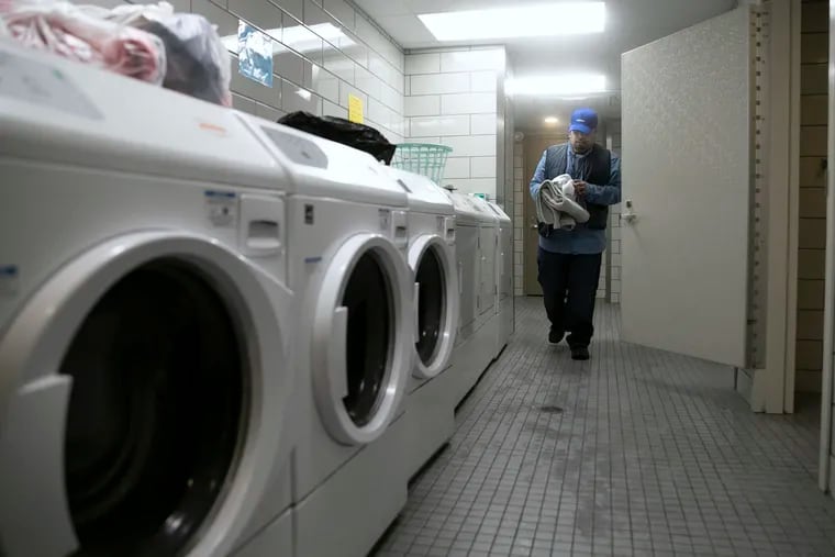 Tyrone Boykin cleans up the laundry and shower room at the Hub of Hope homeless center at Suburban Station in Philadelphia on Tuesday, Feb. 04, 2020. Boykin oversees hospitality services, which includes doing laundry and helping to warm up food.