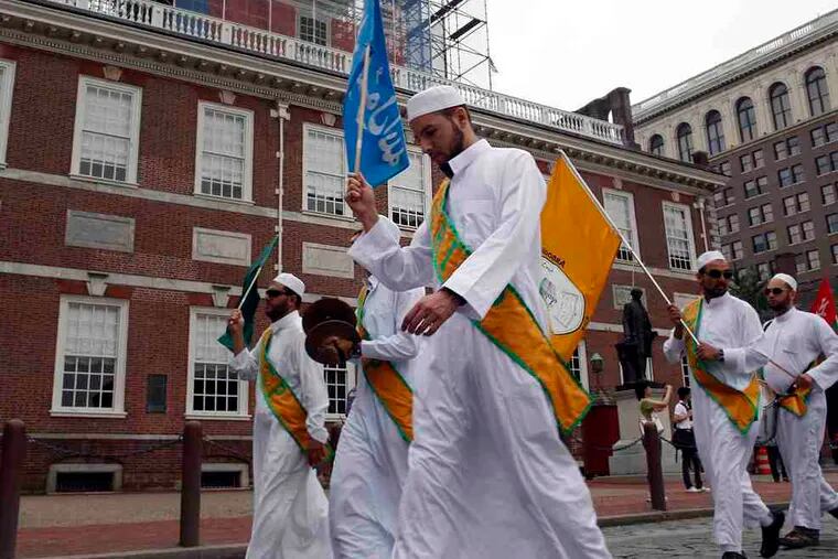 Representatives of the Association of Islamic Charitable Projectsmarch by Independence Hall during the parade portion of the day.