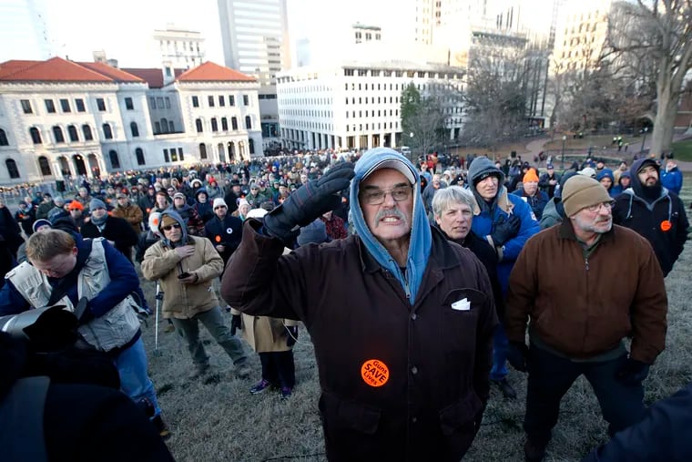 Demonstrators stand on the capitol grounds ahead of a pro gun rally, Monday, Jan. 20, 2020, in Richmond, Va.