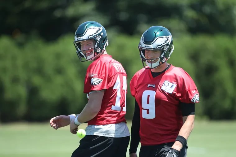Carson Wentz (left) and Nick Foles both participated in on-field drills at Tuesday's mandatory minicamp, although Wentz was still limited.