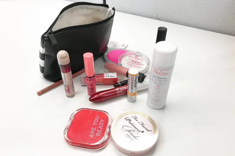 I dumped out the contents of my makeup bag for your benefit.