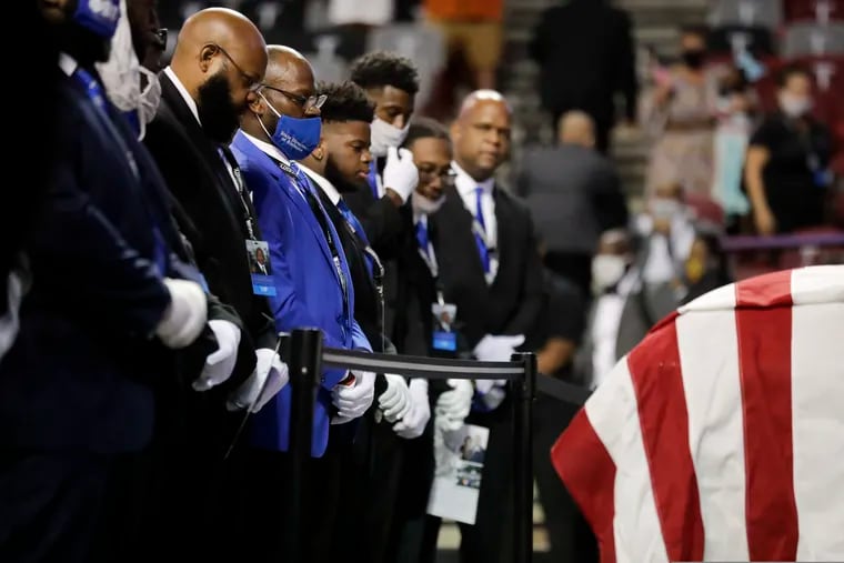 Fraternity members sing in front of the casket of the late Rep. John Lewis, D-Ga., during a service celebrating "The Boy from Troy" at Troy University on Saturday, July 25, 2020, in Troy, Ala. Lewis, who carried the struggle against racial discrimination from Southern battlegrounds of the 1960s to the halls of Congress, died Friday, July 17, 2020.