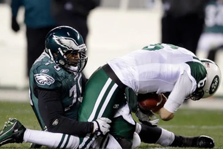 Juqua Parker drags down Jets' QB Mark Sanchez for a sack during the second half of Sunday's game. (Matt Slocum/AP Photo)