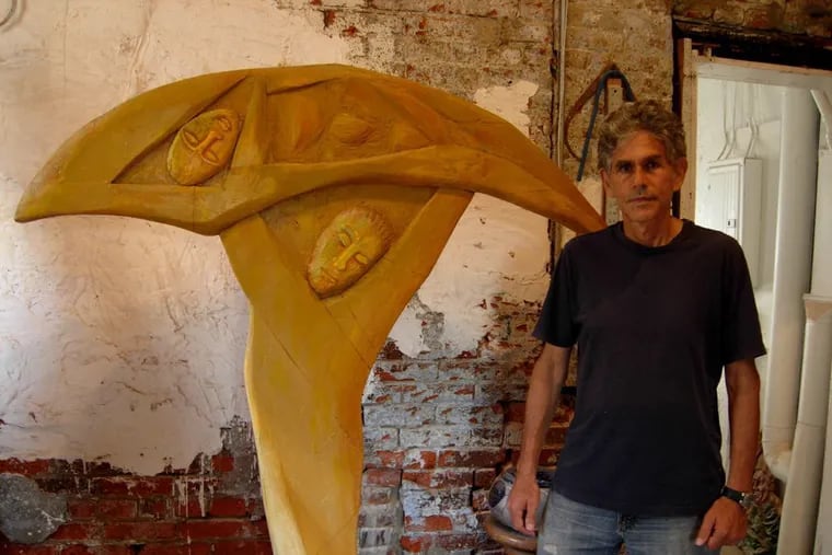 Joe Brennan with his sculpture of Jacob wrestling with the angel, one of the artist's recurring themes. (handout)
