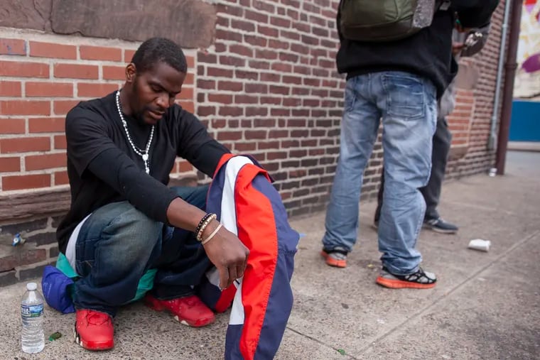 Andre Burton, 30, who uses heroin, sits against a wall around the corner from Prevention Point, a needle exchange and nonprofit providing services to those suffering from addiction, in Kensington on Tuesday afternoon, May 14, 2019. He says he uses Narcan on about five people a week in the neighborhood. A study recently released by the city found that Philadelphia’s overdose deaths dipped overall in 2018, but are "still at crisis levels."