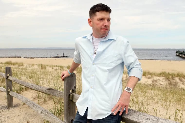 Eric Dunham walks along the beach near his northern New Jersey home. Dunham had a double organ transplant last year at Jefferson Hospital.