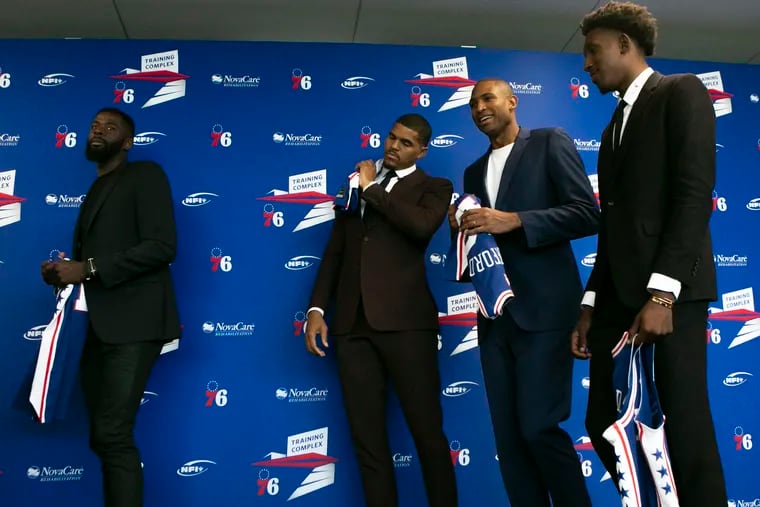 From left, James Ennis, Tobias Harris, Al Horford, and Josh Richardson walk off after posing for phots with their jerseys after an introductory press conference introducing both new and resigned players at the Philadelphia 76ers Training Complex in Camden, NJ on Friday, July 12, 2019.
