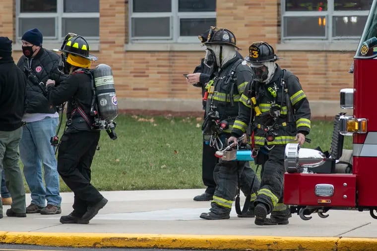 Fire Department personnel exit Haddon Township High School on Friday after a student had brought a potentially dangerous substance into the school, the district said in a statement.