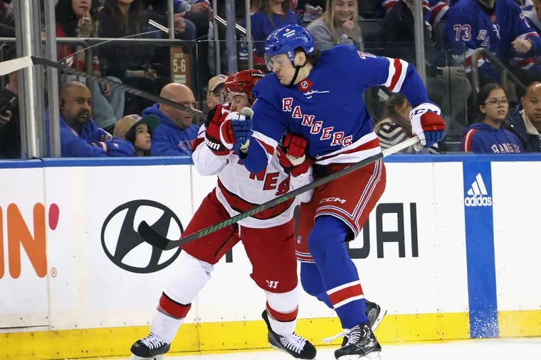 Matt Rempe #73 of the New York Rangers checks Tony DeAngelo #77 of the Carolina Hurricanes in Game One of the Second Round of the 2024 Stanley Cup Playoffs at Madison Square Garden on May 05, 2024 in New York City.  (Photo by Bruce Bennett/Getty Images)