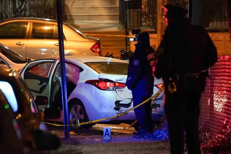 Police videotape the scene at Nedro Avenue and Opal Street in the city’s East Germantown section Wednesday Dec. 27, 2017, after police shot a man, who later died.