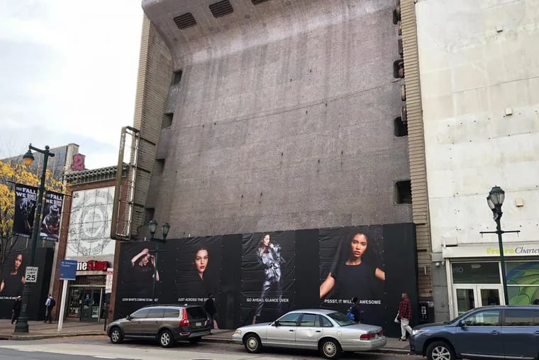 The former Robinson department store building at 1020 Market St. behind billboards advertising the Fashion District Philadelphia project across the street.